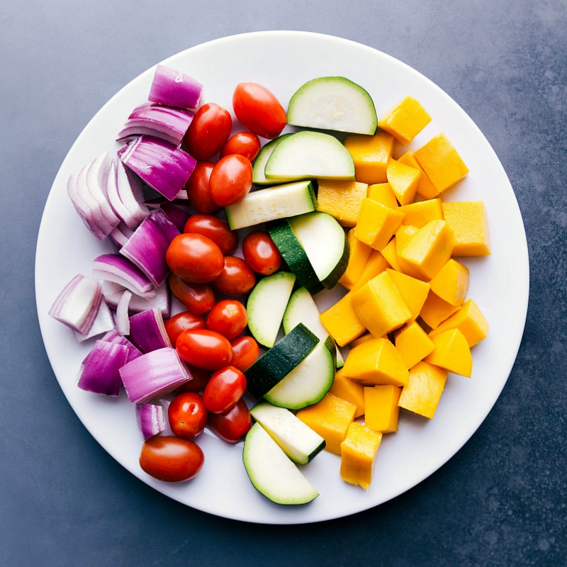 Fresh and Vibrant Ingredients for Grilling Bright, vibrant, fresh fruit and vegetables on a plate before being grilled.