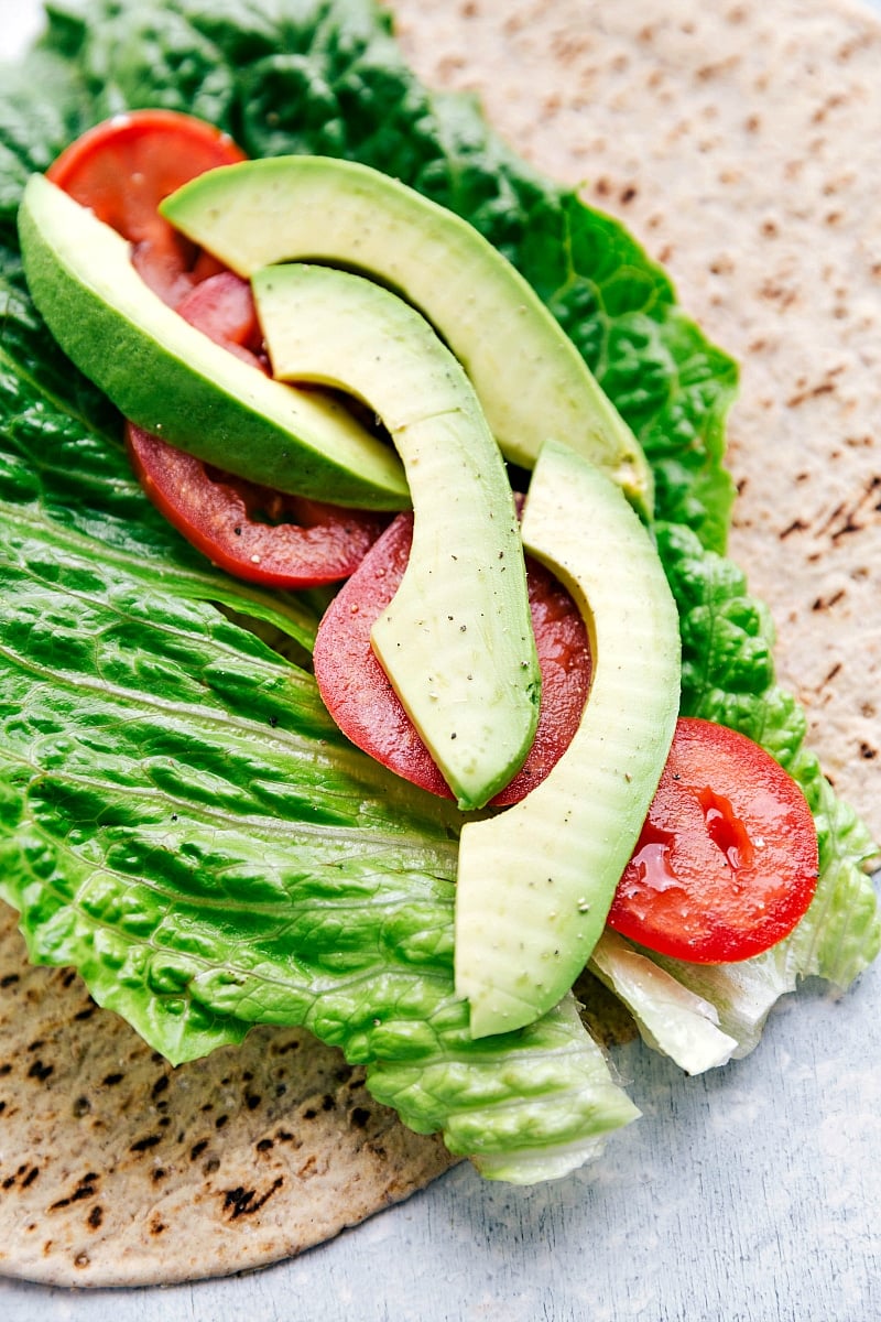 Our absolute favorite chicken salad Tortilla with lettuce, tomatoes, and avocado on it for Chicken Salad Wraps.