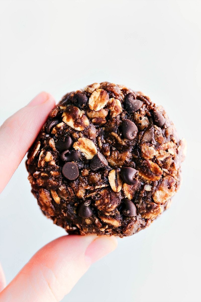 The best ever Chocolate-Peanut Butter Breakfast Cookies are loaded with delicious and satiating ingredients! No baking required and great for on-the-go mornings! Recipe via ChelseasMessyApron #dessert #healthier #quick #easy #simple #best #chocolate #peanutbutter #breakfast #cookies Chocolate-Peanut Butter Breakfast Cookies being held to show size and texture