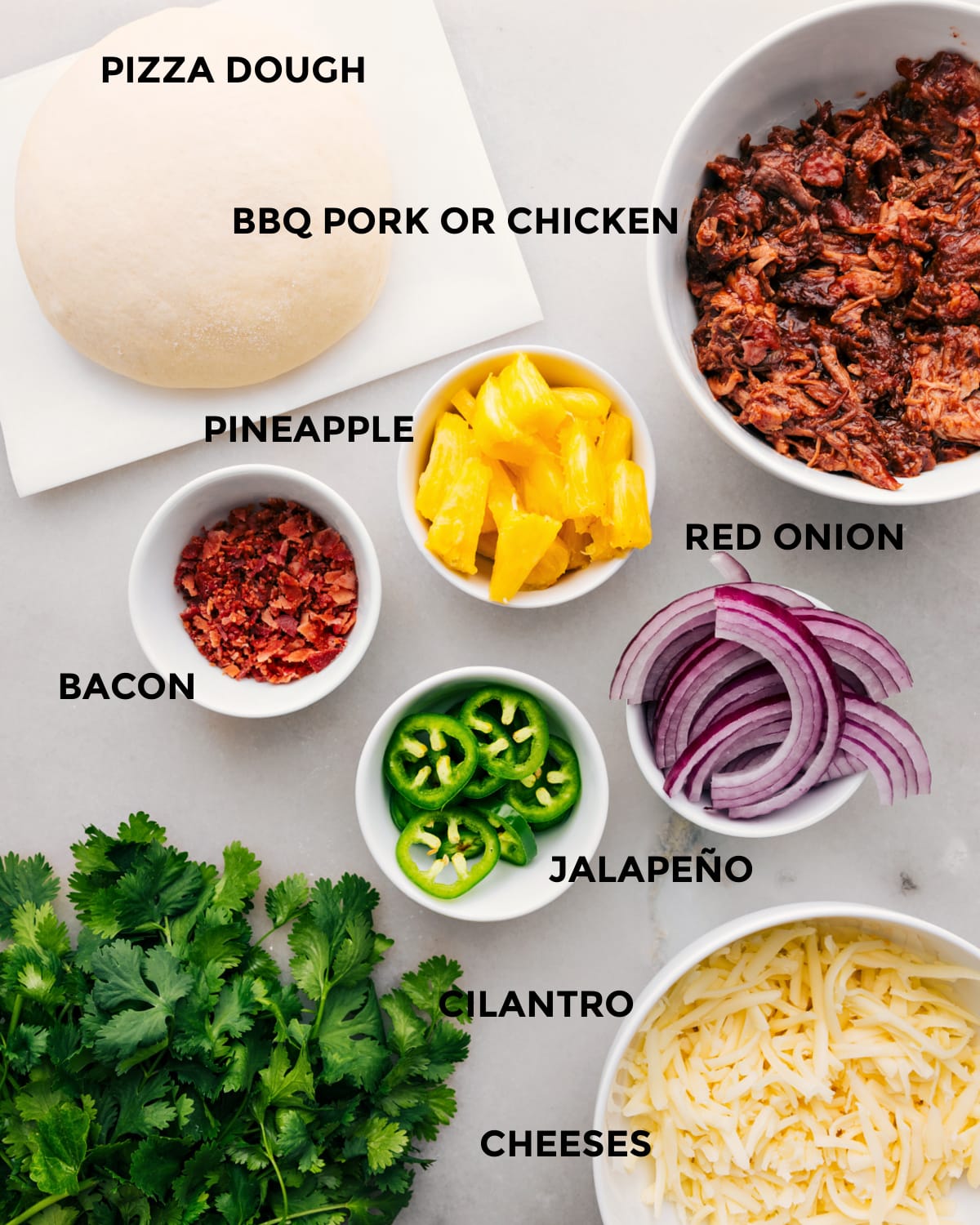 Ingredients In BBQ Chicken Pizza Recipe All the ingredients for this recipe are prepped for easy assembly, including the dough, meat, pineapple, red onion, jalapeno, cheese, and cilantro.