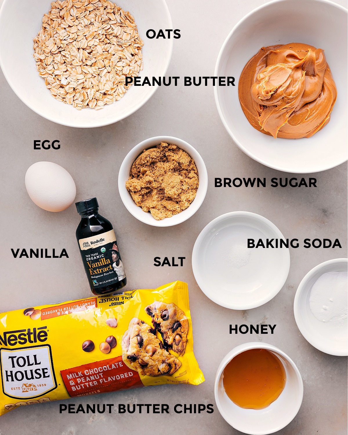 Ingredients In Healthy Breakfast Cookies All the ingredients prepped for easy assembly, including oats, peanut butter, sugar, baking soda, salt, vanilla, honey, and peanut butter chips.
