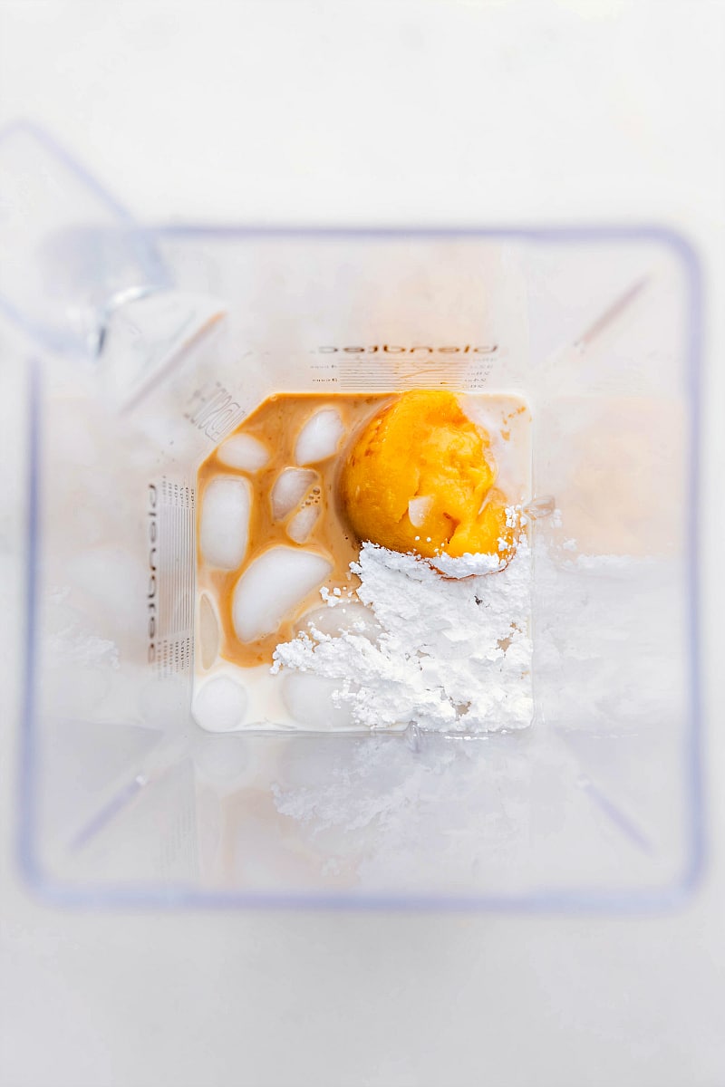 Orange Julius recipe Ingredients being added to the blender.