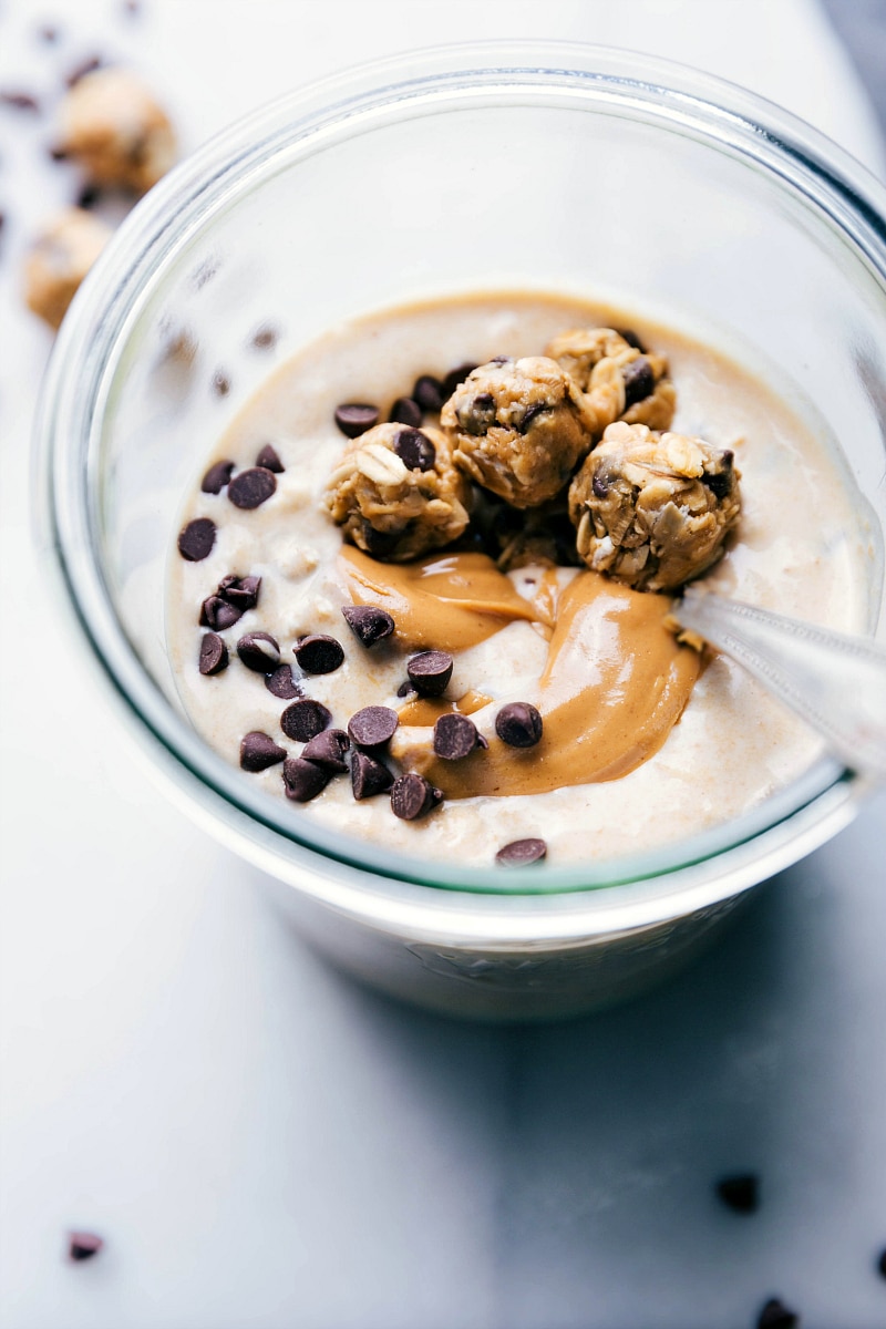 Ready-to-Eat Peanut Butter Cookie Overnight Oats Finished peanut butter cookie overnight oats, ready to be eaten, with a spoon in the cup, a delicious breakfast.
