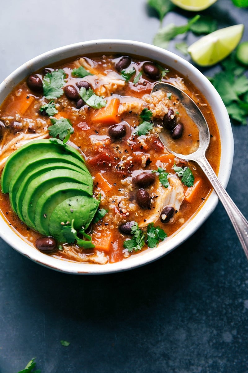 Sweet Potato Chicken Soup in a Bowl with Fresh Herbs and Avocado A bowl of sweet potato chicken soup, topped with fresh herbs and avocados, ready to be enjoyed as a delicious and wholesome meal.