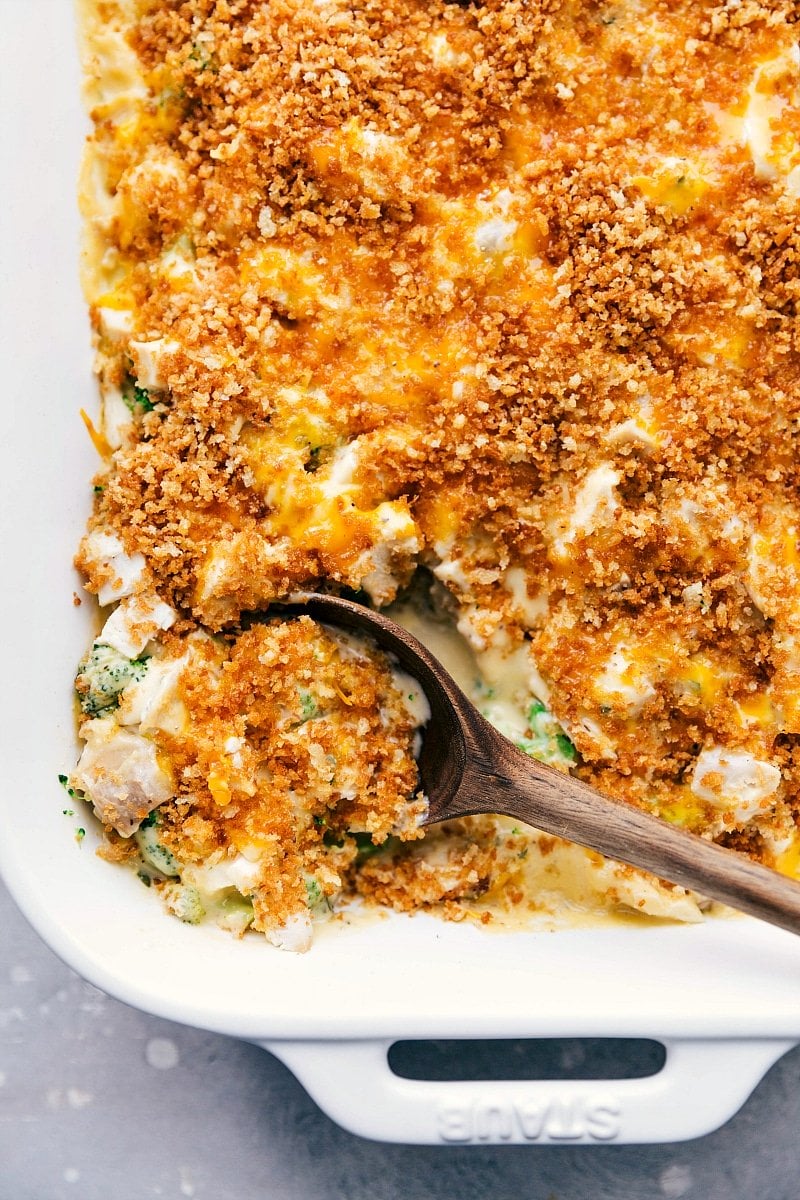 Chicken Divan Fresh from the Oven - A Peek Inside Freshly baked chicken divan in a casserole dish with a serving being scooped out to show the creamy interior.