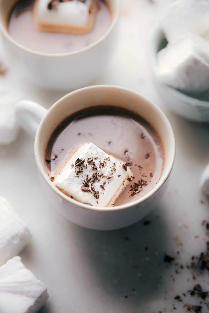 Cozy Cup of Hot Chocolate with Homemade Marshmallows and Chocolate Shavings - A Warm Indulgence Homemade marshmallows floating in a cup of hot chocolate, topped with chocolate shavings.