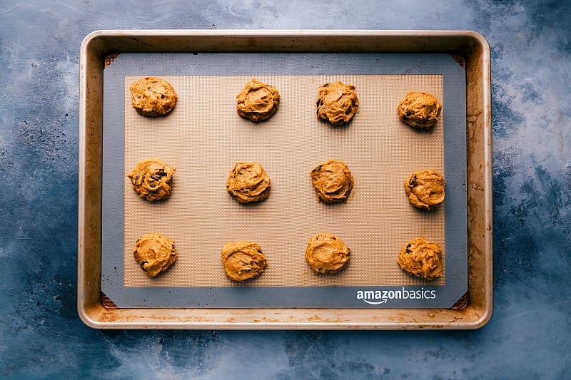 Pumpkin Cookie Dough Ready for Baking Portioned scoops of pumpkin cookies with cake mix dough arranged on a sheet pan, ready for baking.