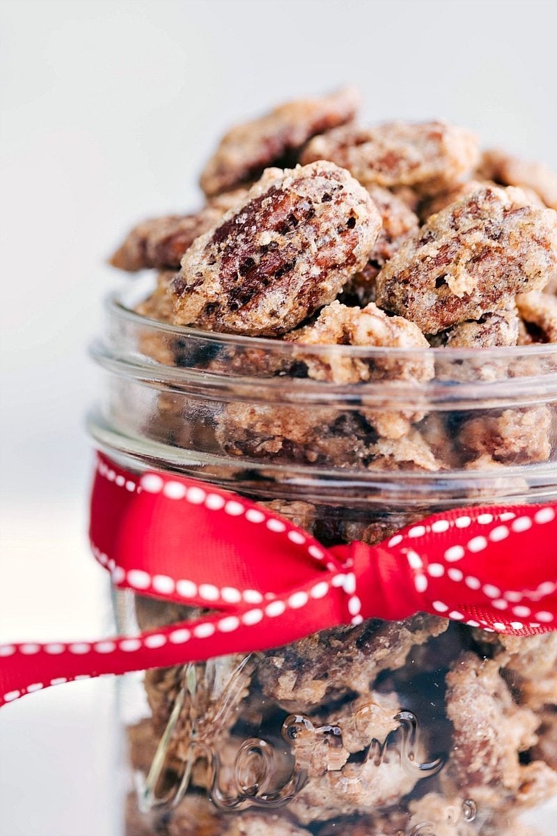 Jar of Candied Pecans Recipe with red ribbon around the jar.