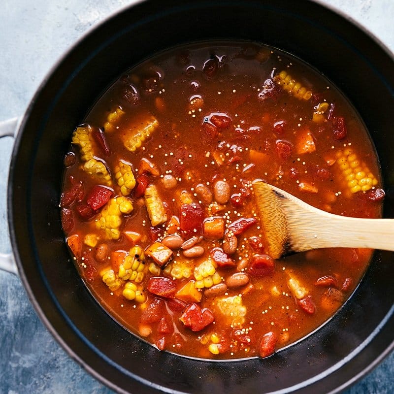 Combining Veggies and Beans in Pot - Creating a Flavorful and Complementary Mix for Quinoa Chili Vegetables and beans being added to the pot and mixed together, blending delicious and complementary flavors.