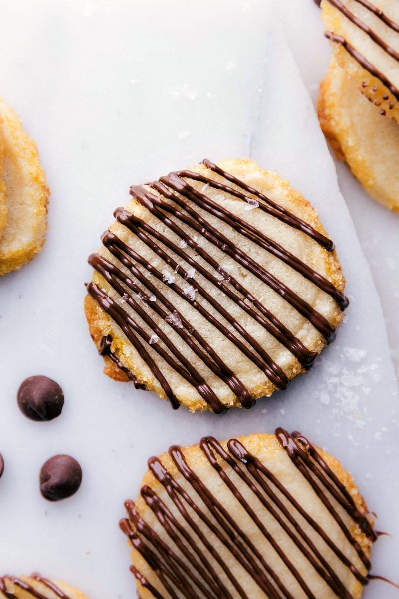 Delectable Shortbread Cookies with Chocolate Drizzle Shortbread cookies with a tempting chocolate drizzle.