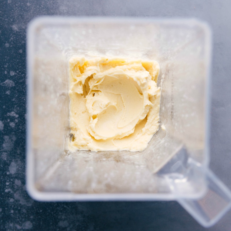 Blended to Perfection: Creamy Pineapple Mixture for Homemade Dole Whip Creamy pineapple mixture in a blender, perfectly blended.