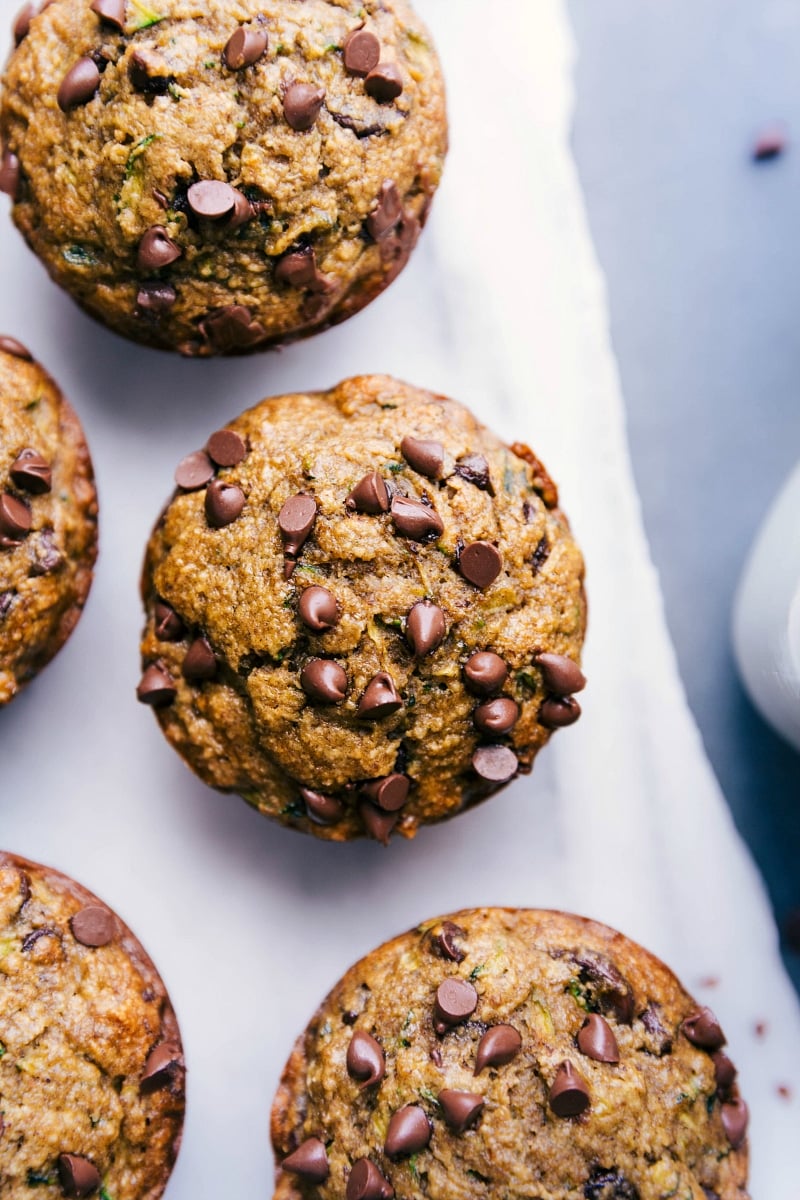 Freshly Baked Gluten-Free Zucchini Muffins with Mini Chocolate Chips Gluten free zucchini muffins freshly out of the oven, topped with mini chocolate chips, ready to be enjoyed as a delicious breakfast or snack.