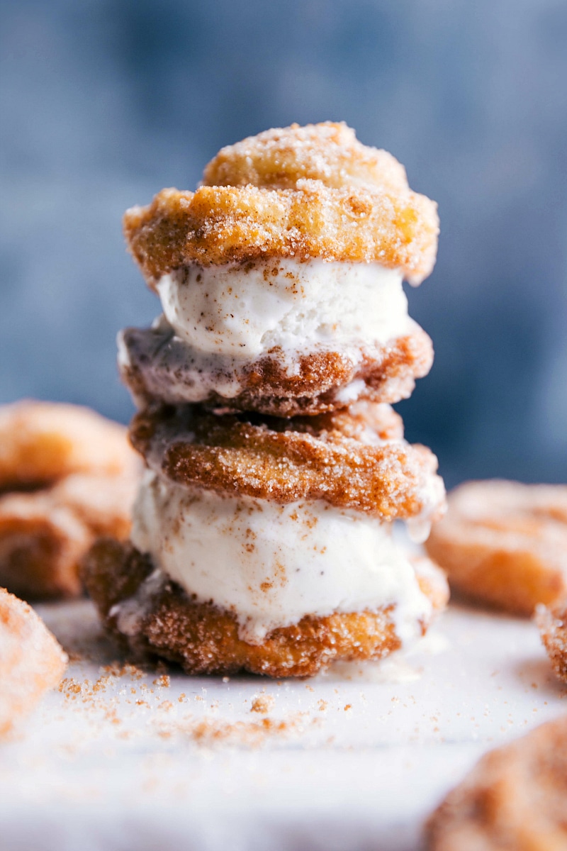 Double-Decker Ice Cream Churro Sandwich with Ice Cream Two ice cream churro sandwiches stacked with ice cream oozing out the sides.
