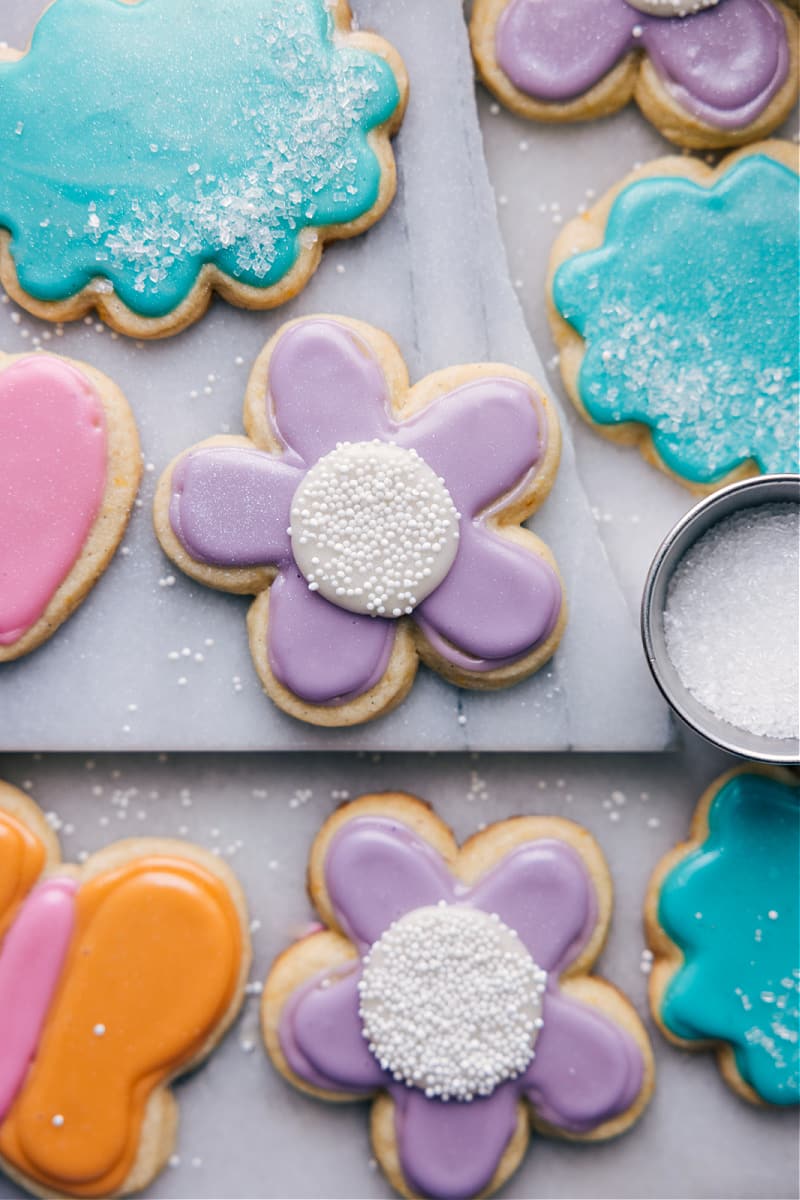 Our favorite Cut-Out Sugar Cookie Recipe is my go-to when using a cookie cutter! A simple, but delicious cookie recipe with stunning results and minimal hands-on or chilling time. Plus, the sugar cookie icing is easy to work with and so tasty (unlike a lot of royal icing recipes.) Recipe via ChelseasMessyApron #dessert #best #quick #easy #simple #treat #fresh #frosting #icing #icedsugarcookies #cutout #sugar #cookie #recipe Overhead image of the Cut-Out Sugar Cookies ready to be enjoyed