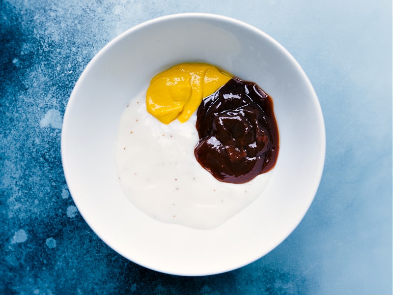 This Chick-Fil-A Sauce recipe has only three ingredients and can be easily made right at home! This addictive sauce is ultra creamy with a sweet, tangy flavor and a hint of smokiness. Recipe via ChelseasMessyApron #side #dip #best #quick #easy #simple #chickfila #sauce Overhead image of all the ingredients in the bowl for this Chick-Fil-A Sauce recipe