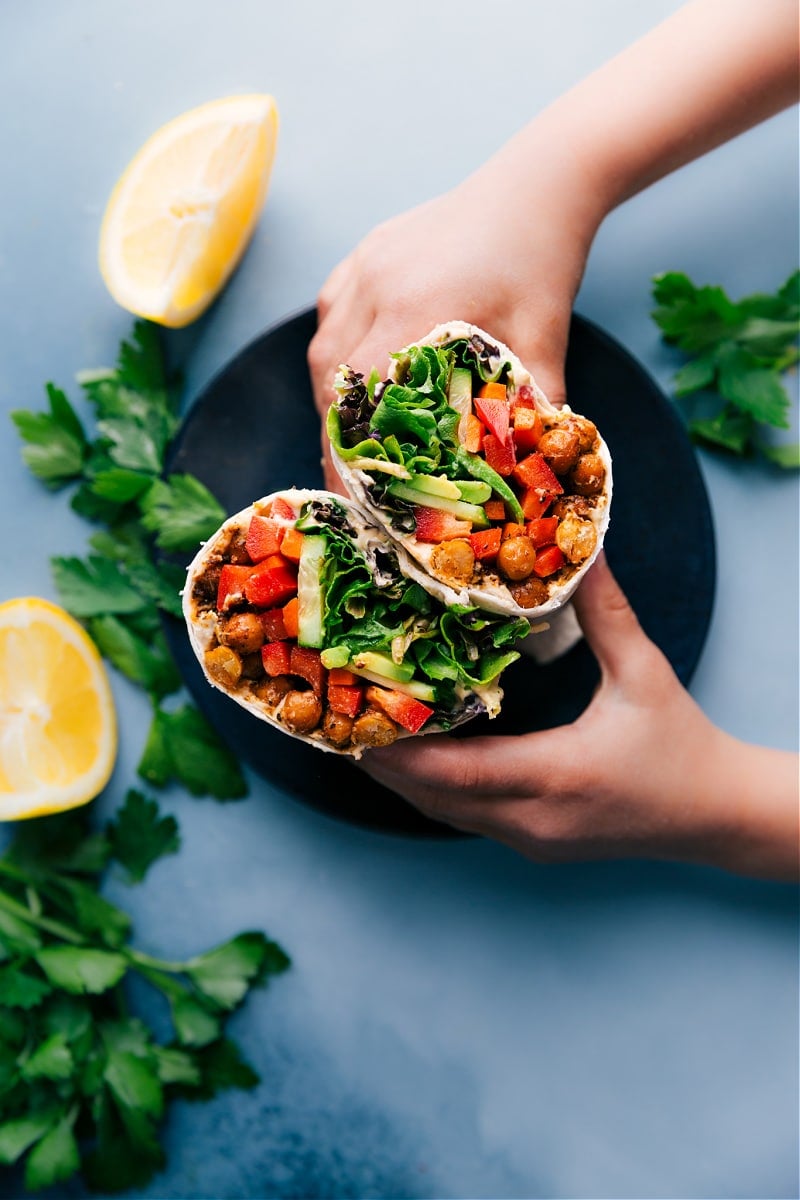 Easy, 30-minute Hummus Wraps start with tasty, crisp chickpeas, loads of fresh veggies, and smooth hummus-topped tortillas. Recipe via ChelseasMessyApron #healthy #dinner #lunch #quick #easy #simple #best #clean #cleaneating #wholefoods #chickpeas #vegetarian #vegan #hummus #wrap Hummus Wraps