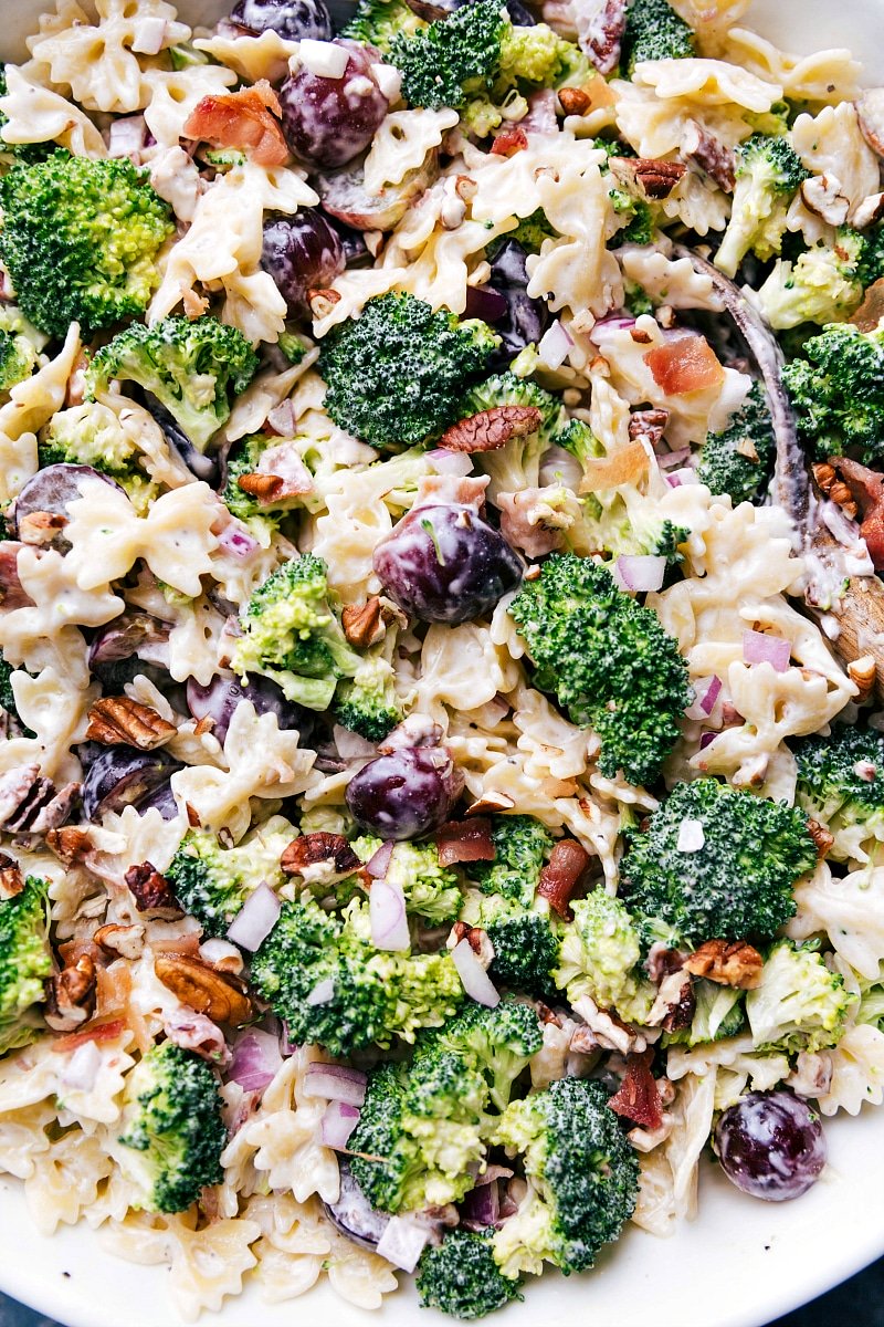 Delicious Broccoli Grape Pasta Salad in a Bowl with Serving Spoon Delicious and healthy side dish in a bowl, ready to be enjoyed.