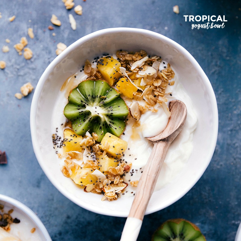 Vibrant Bowl with Fresh Kiwi, Pineapple, and Crunchy Granola Yogurt bowl filled with fresh kiwi, pineapple, and a generous sprinkle of granola.