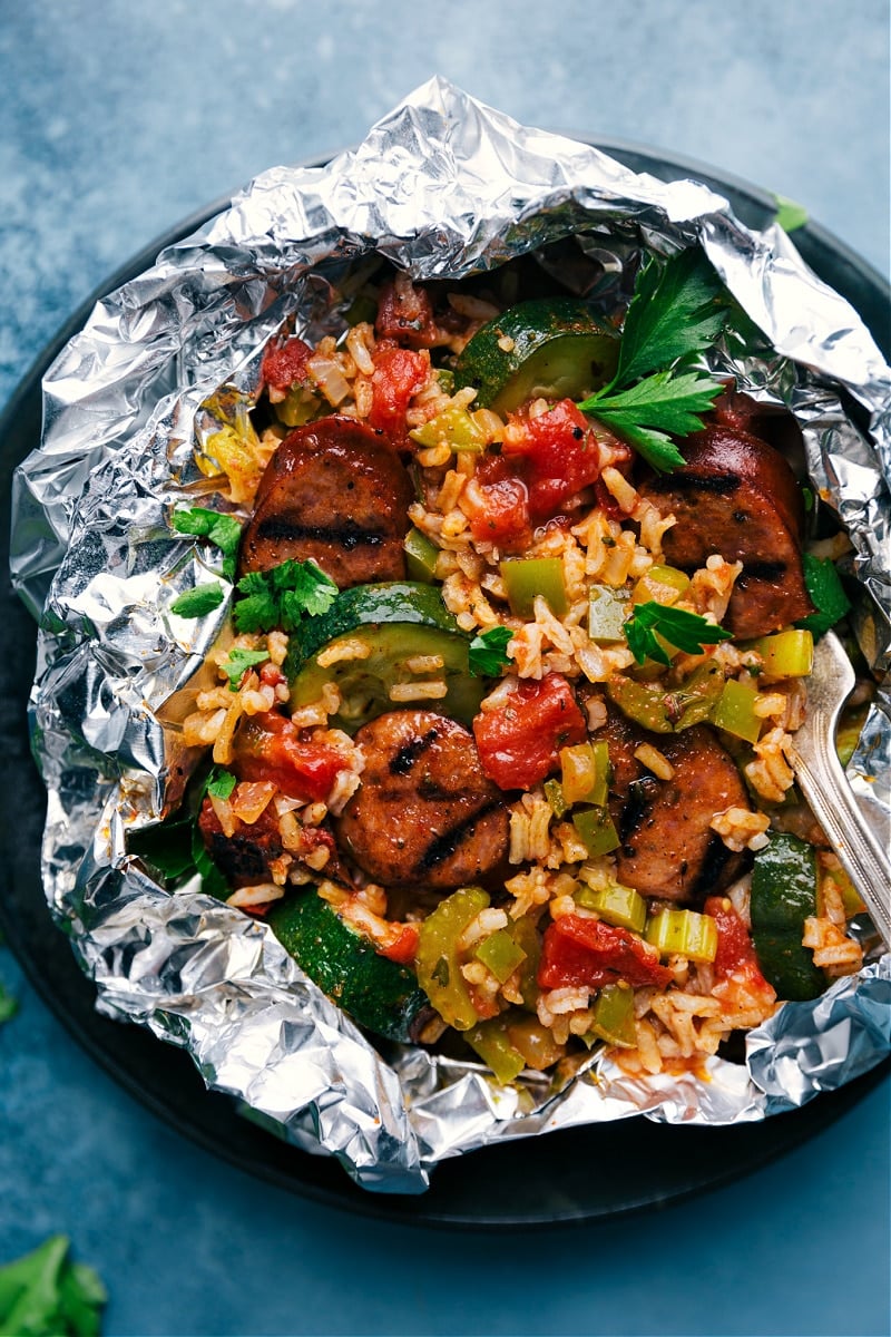 Tin Foil Jambalaya! Mix it all together on some aluminum foil and throw it on the grill or in the oven. Easy prep, loads of flavor! Recipe via ChelseasMessyApron #dinner #campfire #campingfood #grilled #oven #best #quick #easy #simple #sausage #rice #tinfoil #jambalaya Overhead image of the Tin Foil Jambalaya Packets
