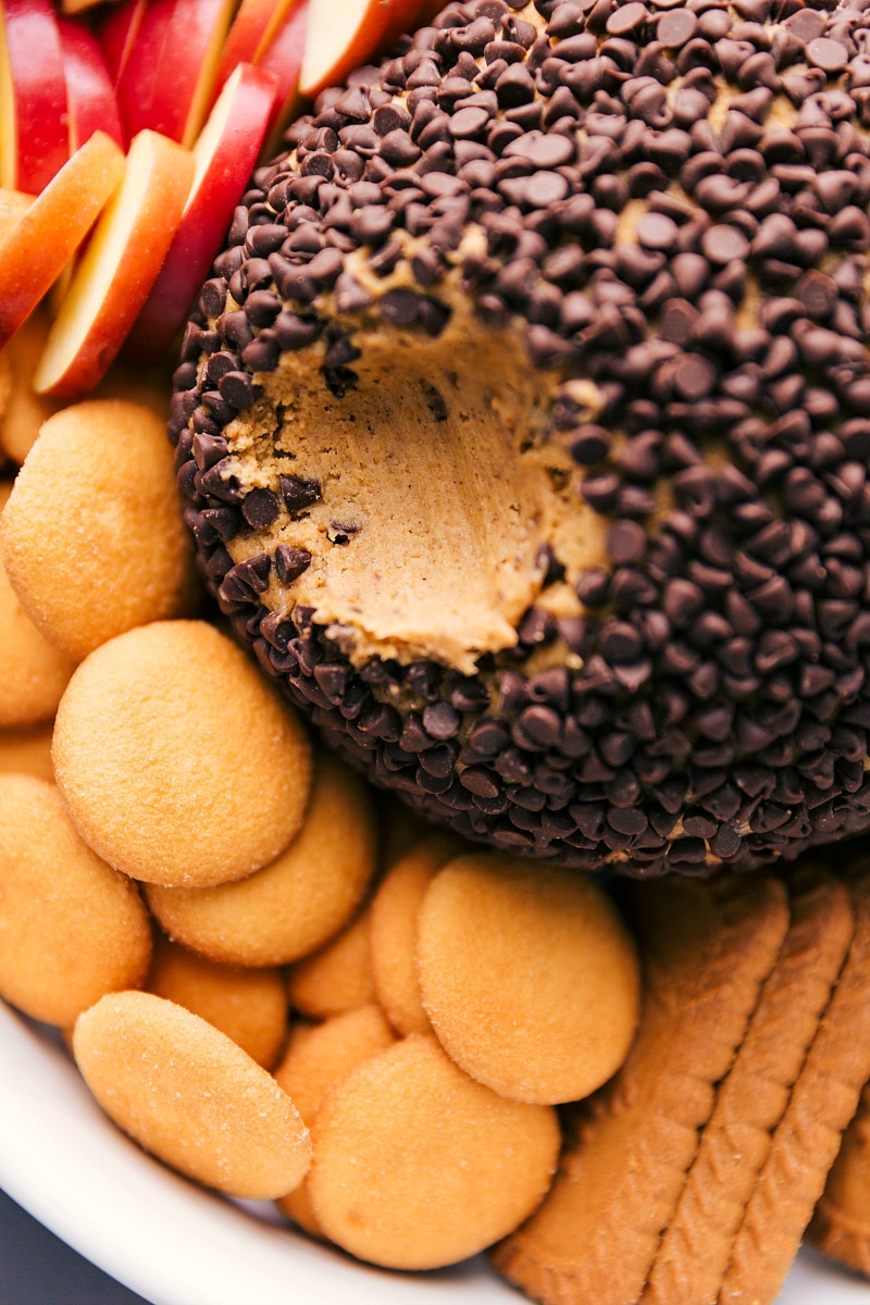 Pumpkin Cheesecake Ball with Smooth Interior The finished dessert, with a bite taken out of it to reveal its smooth and creamy interior, showcasing its irresistible texture and flavor.