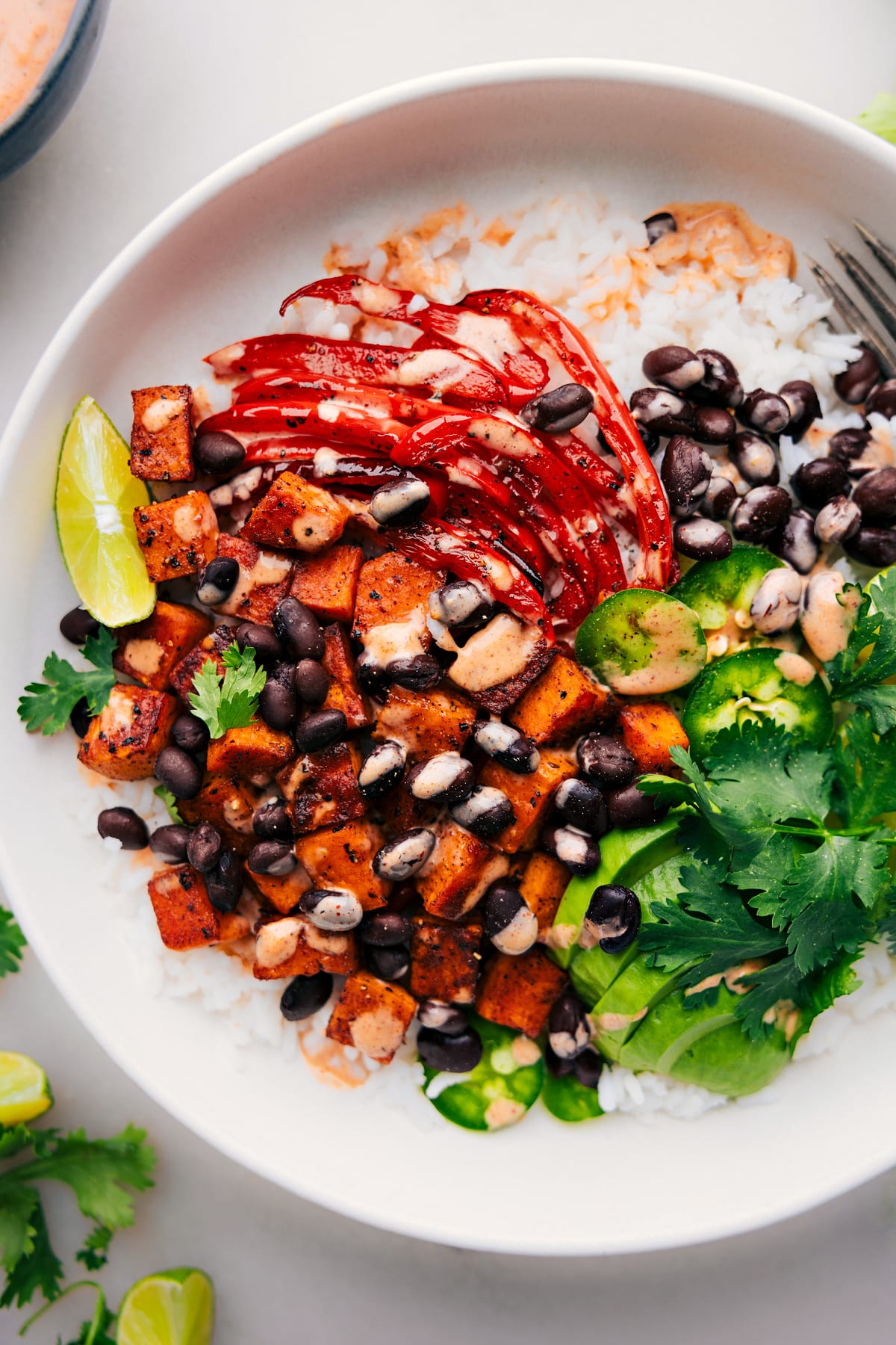 Ready-to-savor Sweet Potato and Black Bean Burrito Bowls Sweet Potato and Black Bean Burrito Bowls, colorfully assembled and ready to be enjoyed.