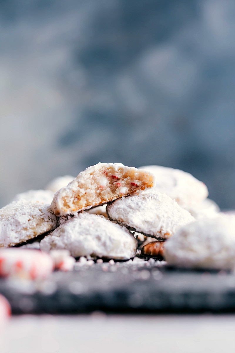 Finished Peppermint Snowball Cookies, Flavor-Packed and Delicious, with a Bite Revealing Delightful Interior Finished snowball cookies with peppermint, delicious and flavor-packed, with a bite taken out to reveal the delightful interior.