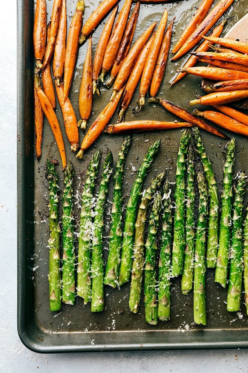An entire Easter Dinner made in an hour (or less), baked in the oven together, and all on 2 sheet pans!ย This is the BEST easter dinner meal! Recipe via chelseasmessyapron #sides #menu #recipes #meat Image of the sheet pan with carrots and asparagus that goes with this easter dinner meals