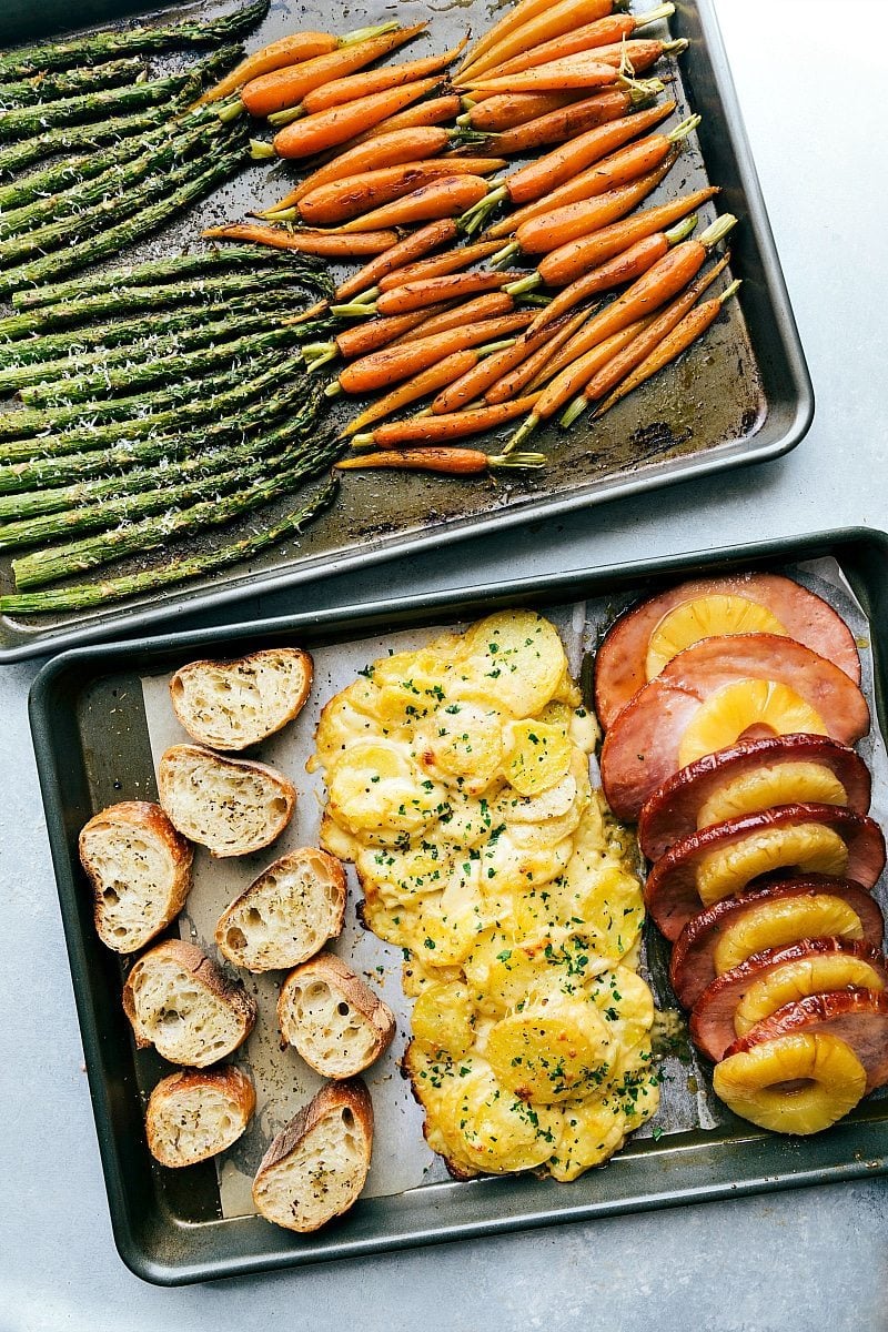 A whole Easter Dinner recipes made in an hour (or less), baked in the oven together, and all on 2 sheet pans!ย Recipe via chelseasmessyapron #sides #menu #recipes #meat Image of all the food on two sheet pans cooked