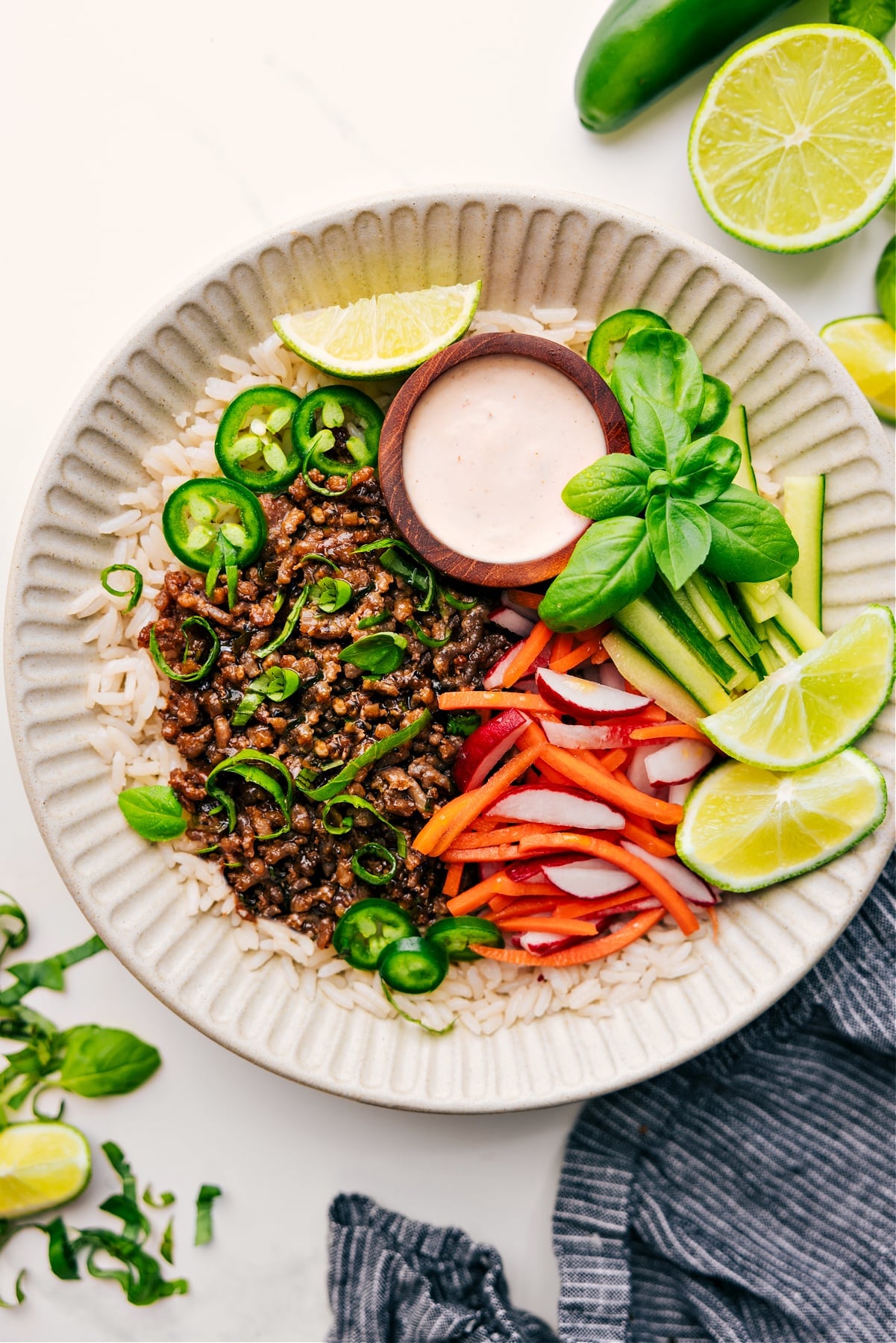 Banh Mi Bowl Recipe Banh Mi Bowl recipe with sauce and fresh herbs.