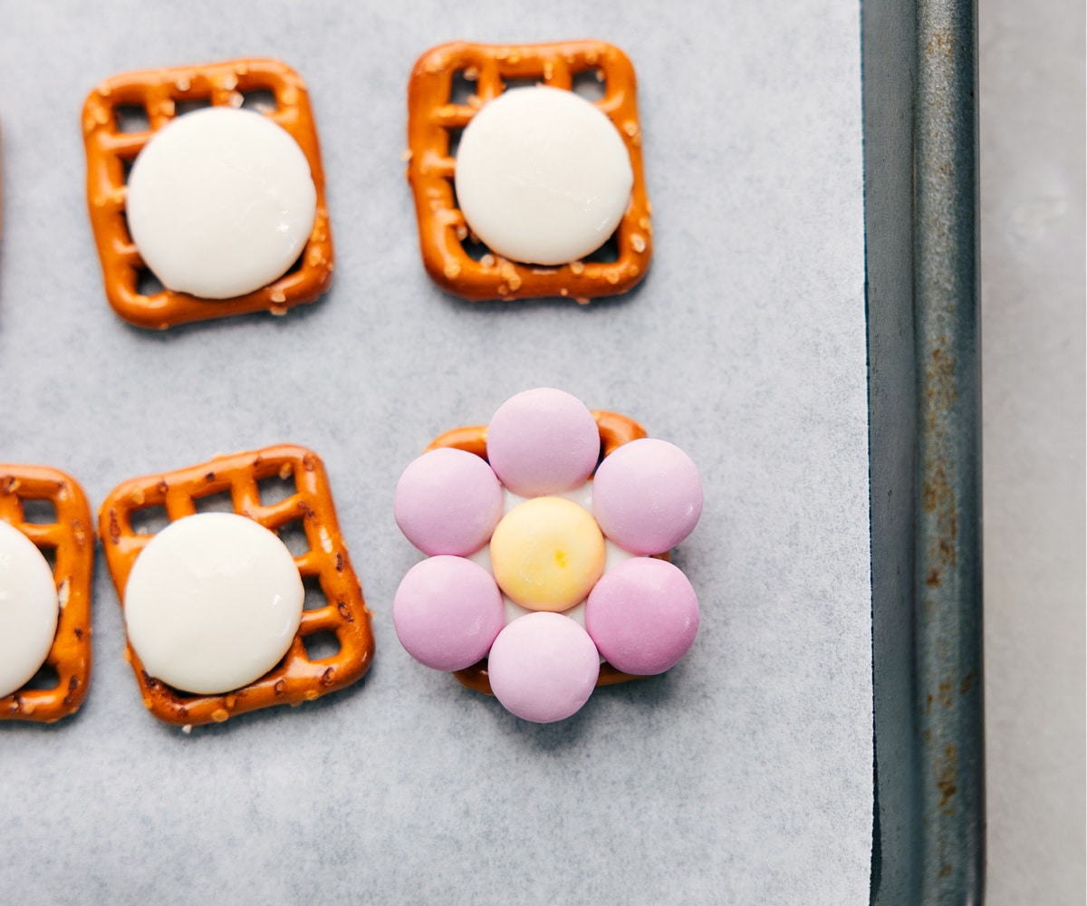 Assembling Flower M&M Pretzels Recipe The M&M's placed on a pretzel to form a flower for these flower pretzels.