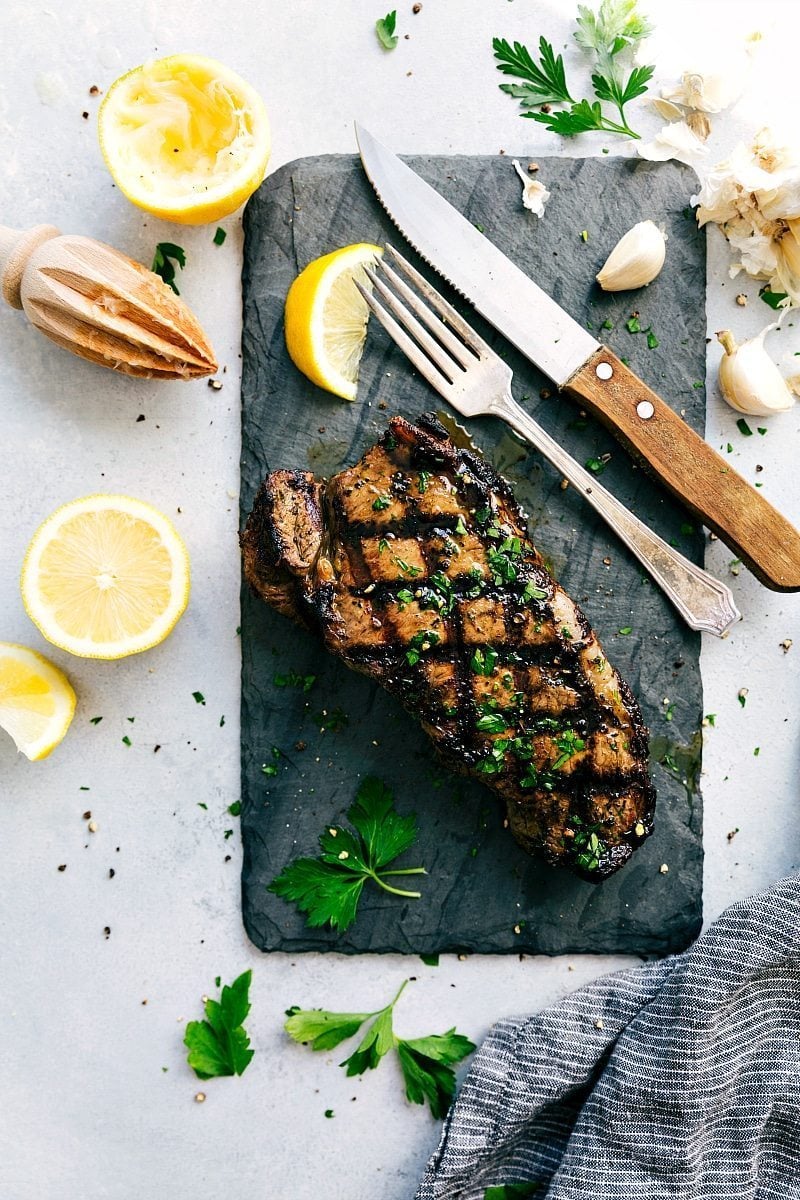 Delicious, juicy, and tender steak that's had some time in the best steak marinade Steak on a cutting board after being cooked in the best Steak Marinade