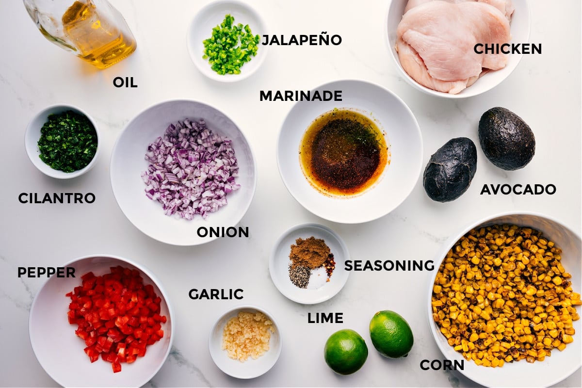 Ingredients In Summer Chicken Recipe All the ingredients for this recipe are prepped and ready for easy assembly, including the meat, jalapeรฑo, marinade, onion, seasonings, corn, lime, garlic, pepper, cilantro, and oil.