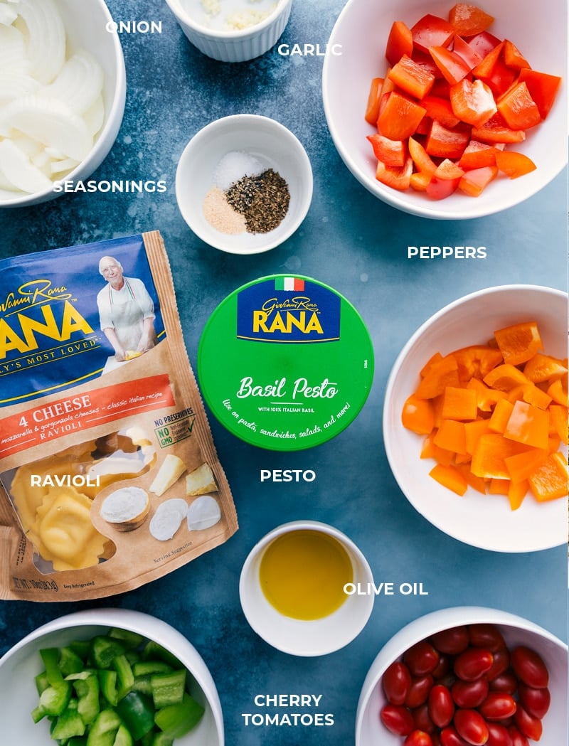 Pesto Ravioli combines perfectly caramelized roasted veggies with tender cheese-filled ravioli and loads of fresh basil pesto. Recipe via ChelseasMessyApron #dinner #quick #easy #simple #roasted #veggies #onetray #tomatoes #pesto #ravioli Ingredient shot-- all the ingredients that go into this dish