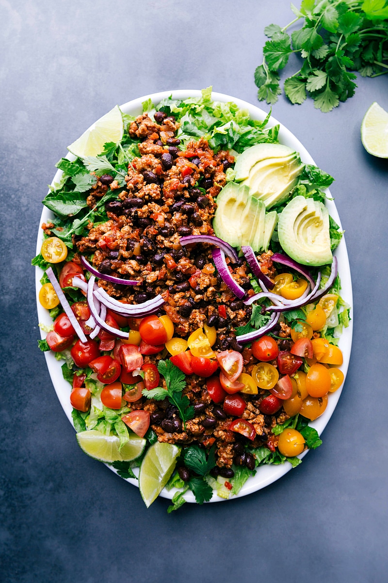 Ground Turkey Taco Salad with a Full Array of Toppings, Ready to Serve Ground turkey taco salad complete with a variety of fresh ingredients on top.
