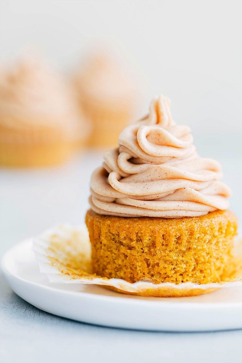 Pumpkin Cupcake With Pumpkin Spiced Cream Cheese Frosting Finished moist pumpkin cupcake with a generous amount of frosting, delicious and ready to be enjoyed for this pumpkin spice desserts roundup.