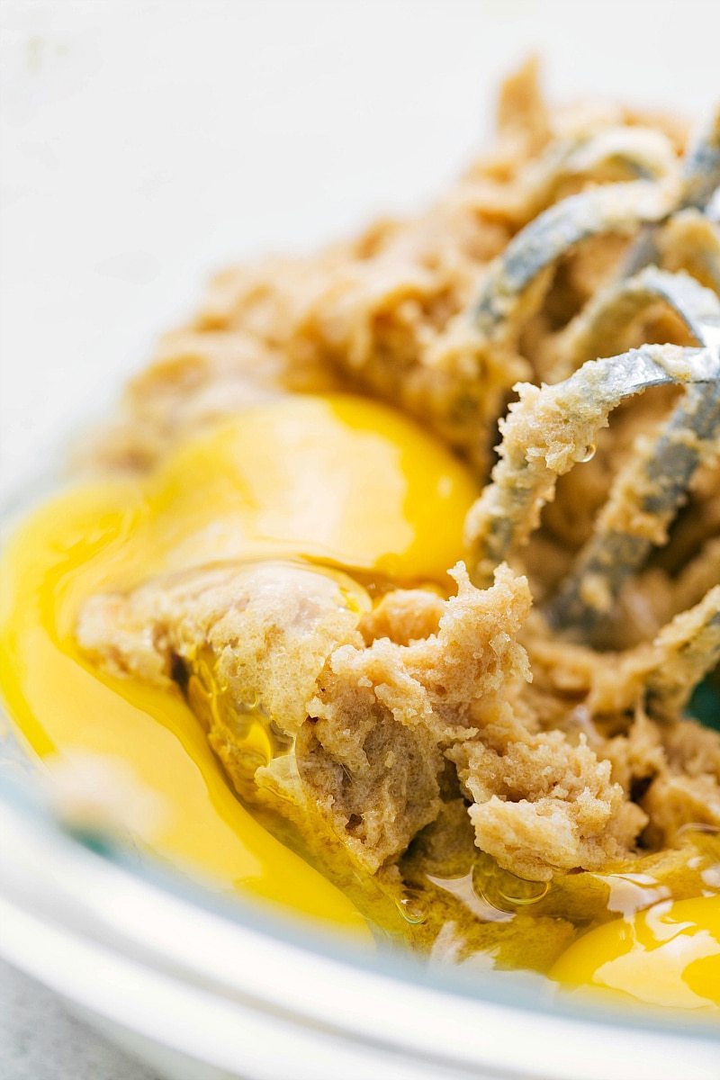 Using Electric Hand Mixer to Combine Egg, Butter, and Sugar for Baking Mixing egg, butter, and sugar with an electric hand mixer.