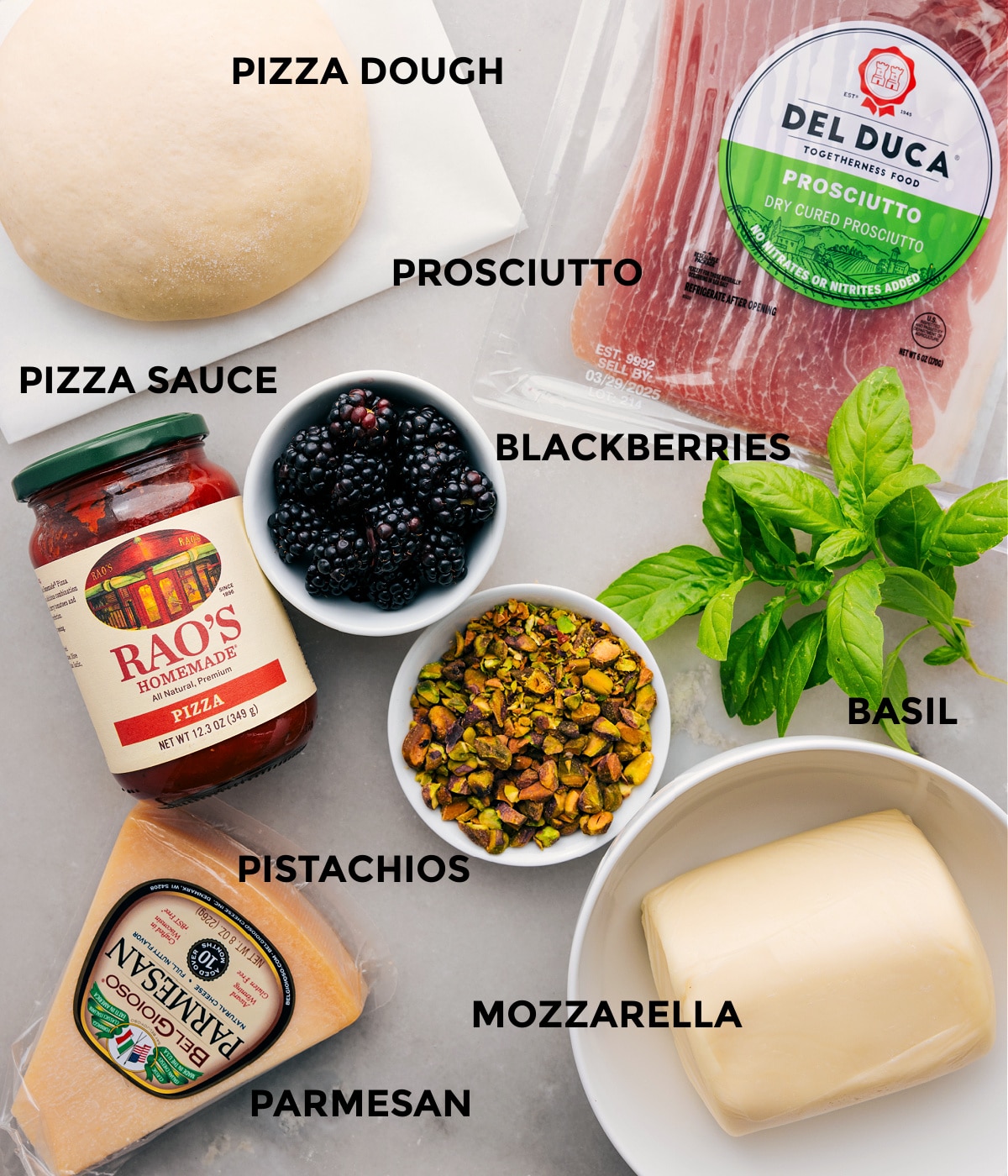 Ingredients In Fresh Basil Blackberry Pizza All the ingredients for this recipe are prepped and ready for easy assembly, including the dough, prosciutto, herbs, berries, sauce, cheese, and pistachios.