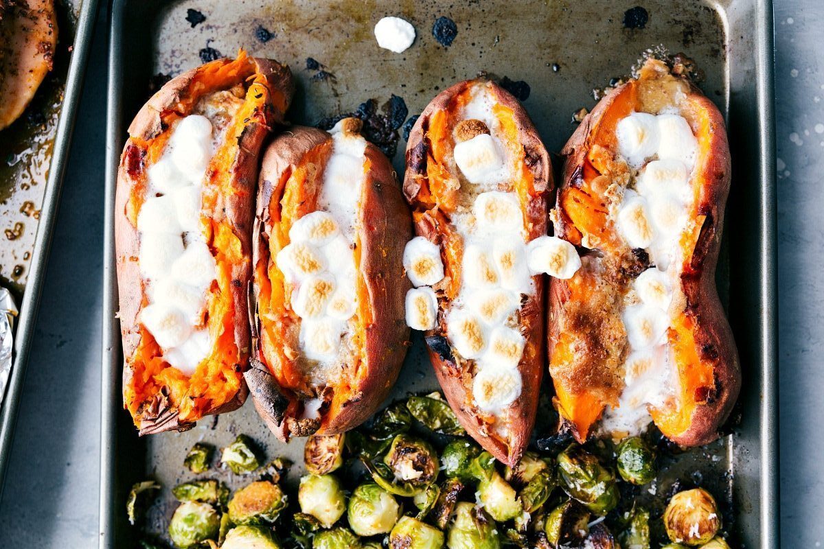 Perfectly Browned Marshmallow-Topped Candied Sweet Potatoes on Sheet Pan Candied sweet potatoes on a sheet pan with perfectly browned marshmallows, ready to serve.