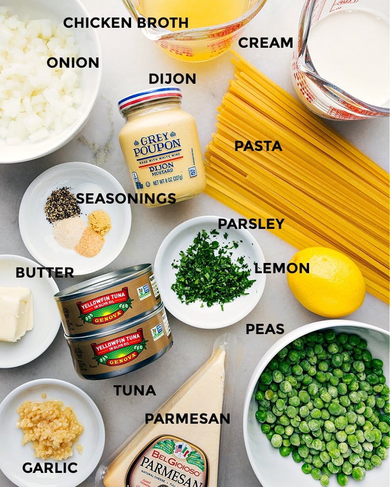 This Creamy Tuna Pasta recipe begins by boiling together fettuccine and sweet peas, then tossing them into a mouthwatering cream sauce. The dish is crowned with olive oil-packed tuna and a fresh hint of lemon. It's a comforting meal the entire family will love and takes minutes to whip together! Recipe via chelseasmessyapron #dinner #quick #easy #simple #familyfriendly #kidfriendly #comfortfood #peas #creamy #tuna #pasta Ingredient shot- image of the ingredients used in this dish