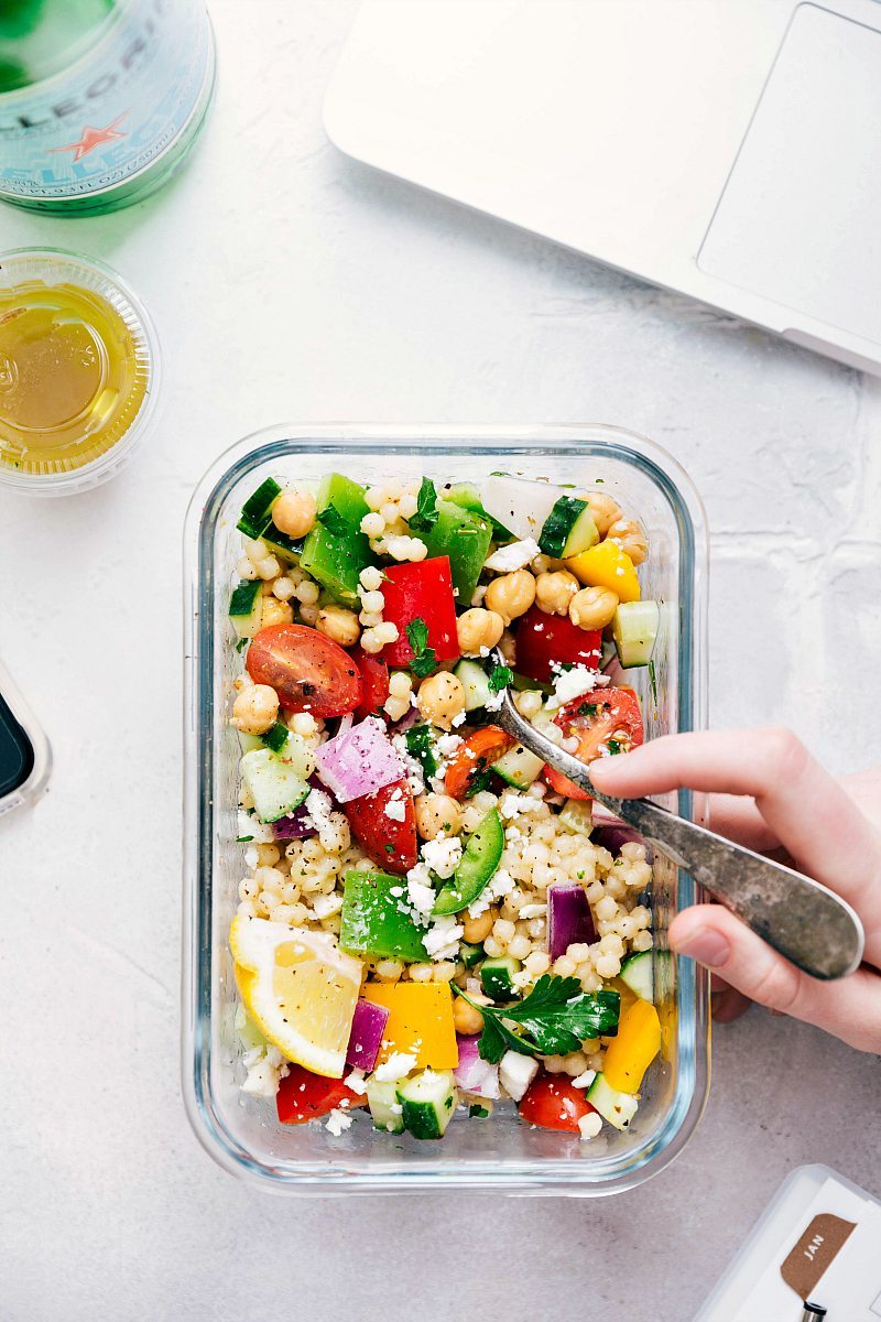 The Best Greek Couscous Salad Recipe Greek couscous salad in a meal prep container ready to be enjoyed.