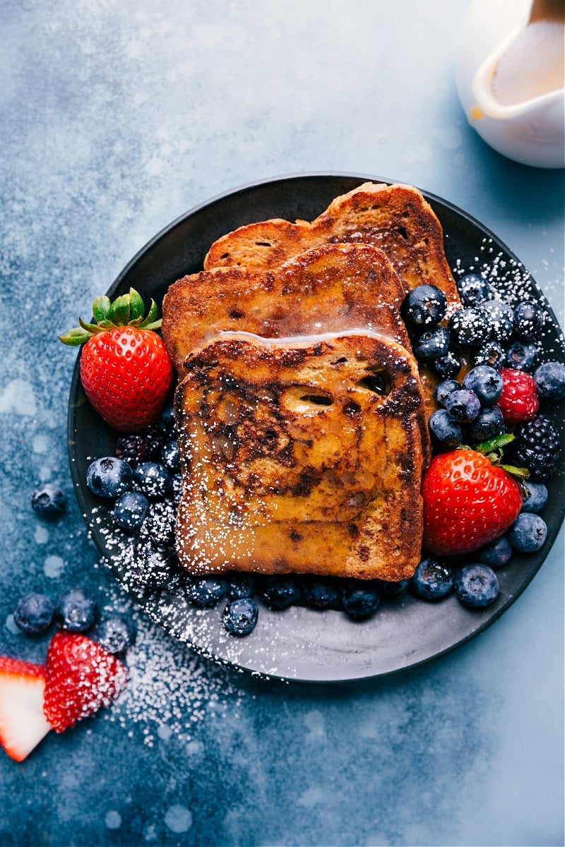 Cinnamon-sugar French toast, topped with whipped cream, fresh berries, and a four-ingredient caramel syrup comes from a famous Utah bakery. This is my adaptation of that recipe! French Toast