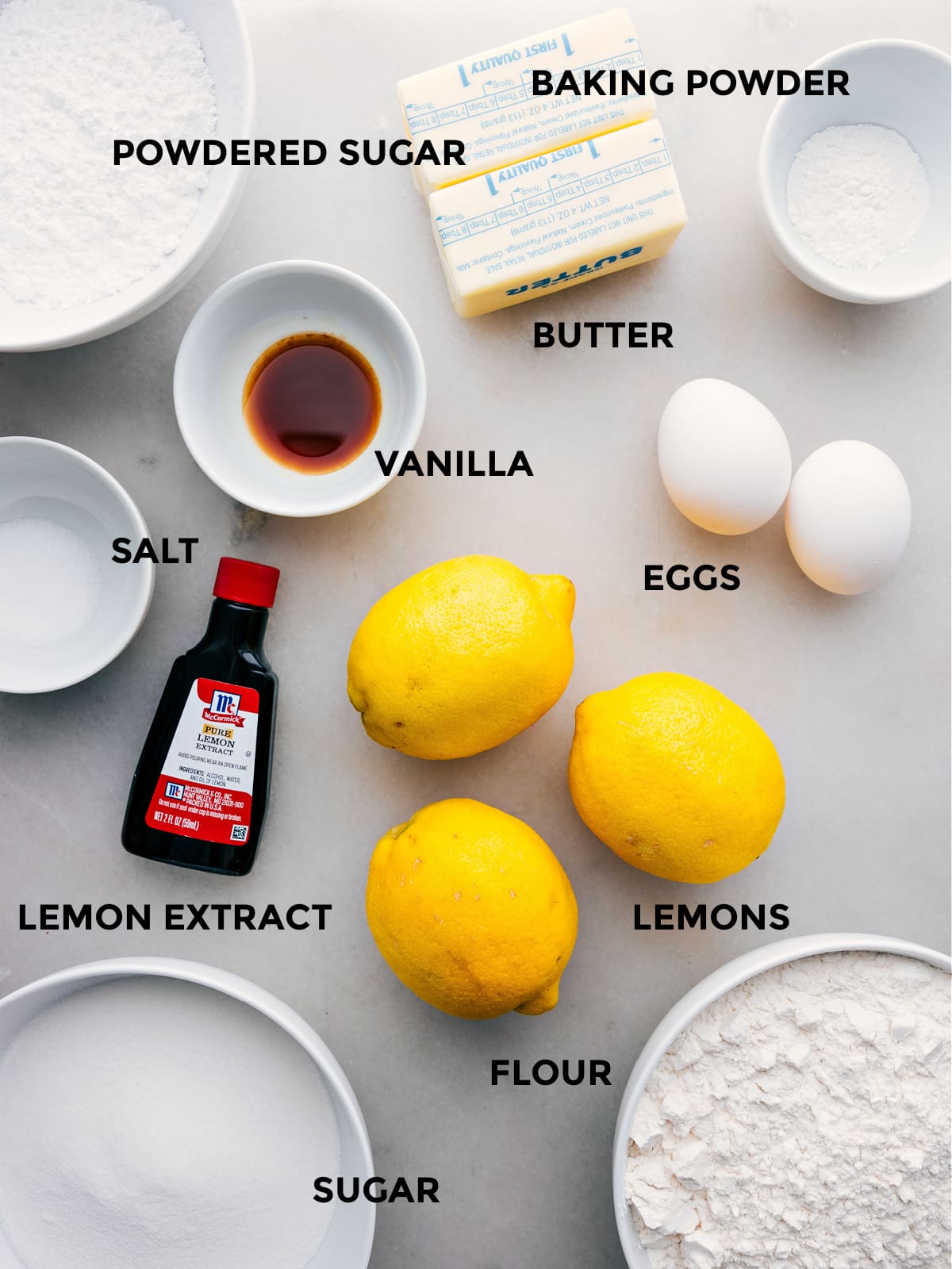 Ingredients In This Lemon Cookies Recipe All the ingredients in this recipe prepped out for easy assembly including the powdered sugar, baking powder, butter, eggs, vanilla, salt, lemons, lemon extract, flour, and sugar.