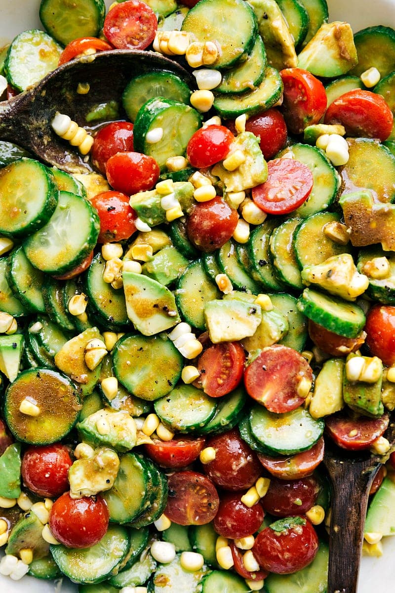 The best cucumber salad recipe! This beauty adds tomatoes, corn and avocado, with a balsamic vinaigrette. Recipe via ChelseasMessyApron.com #cucumbers #cucumbersalad #vegetarian #refreshing #corn #balsamic Cucumber Salad closeup