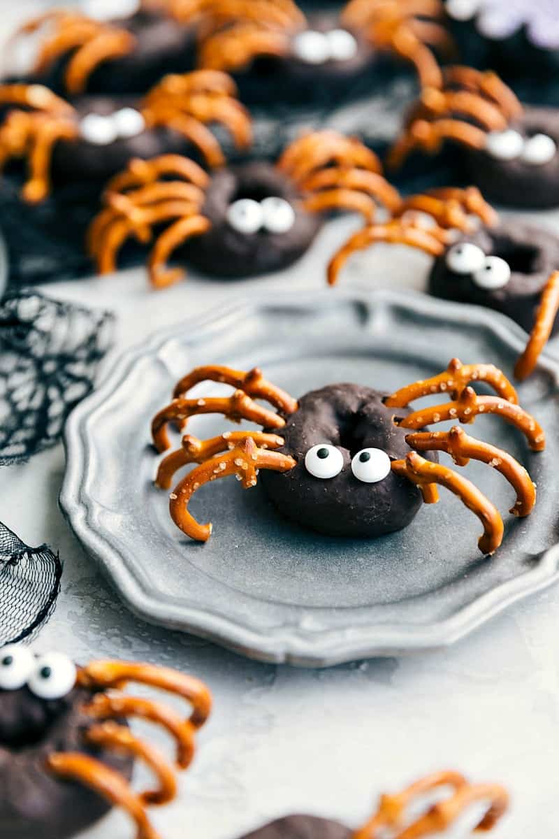 Spider Chocolate Donuts with Candy Eyes and Pretzels Creating Spider Legs Spider chocolate donuts with candy eyes and pretzels coming out to create spider legs.