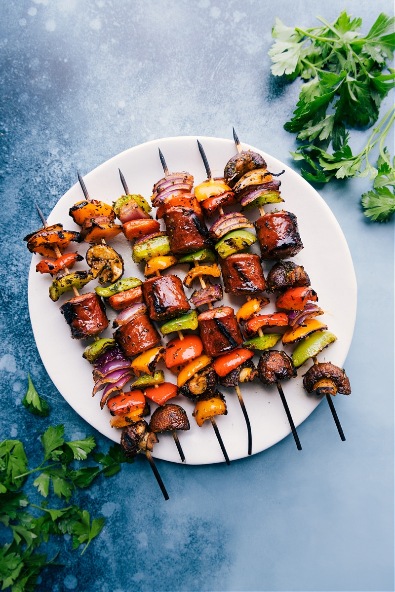 Sausage Kabobs are simple to make, nutritious, and loaded with flavor! Recipe via ChelseasMessyApron #dinner #quick #easy #healthy #whole #whole30 #keto #veggies #grilled #summer #sausage #kabobs Overhead image of the sausage kabobs on a plate