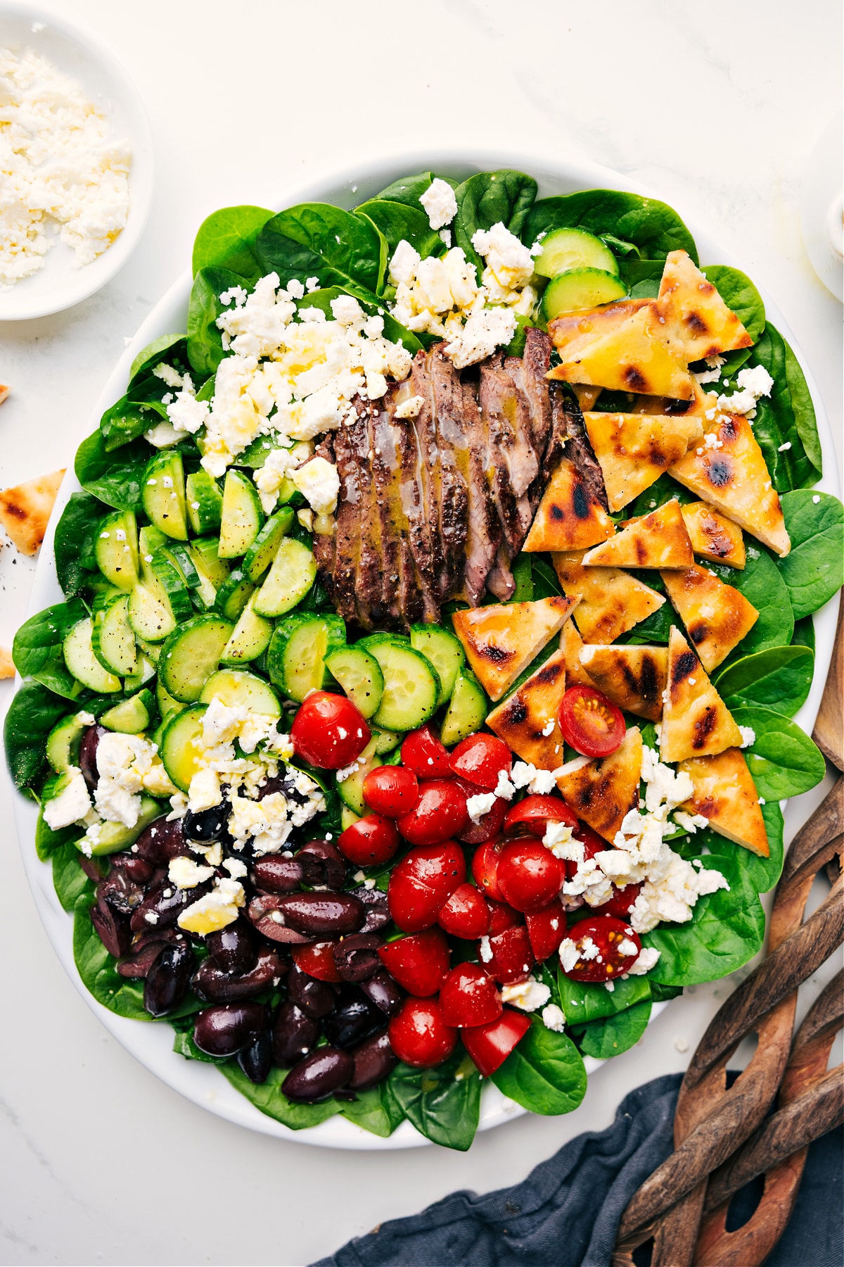 Grilled Steak Salad Recipe served over spinach and drizzled with honey-lemon dressing.