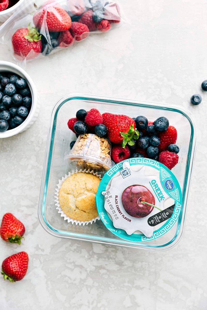 Packed Yogurt Parfait Lunch Yogurt parfait meal in a container, packed with yogurt, fresh fruit, and granola, ready to go.