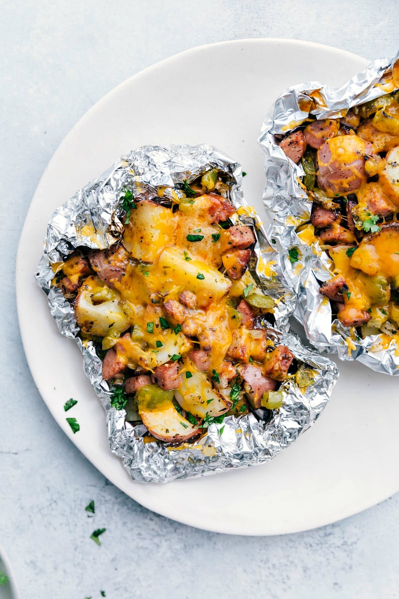 Easy And Delicious Veggie Packed Foil Packs Cheesy sausage and potato foil packs right off the grill.