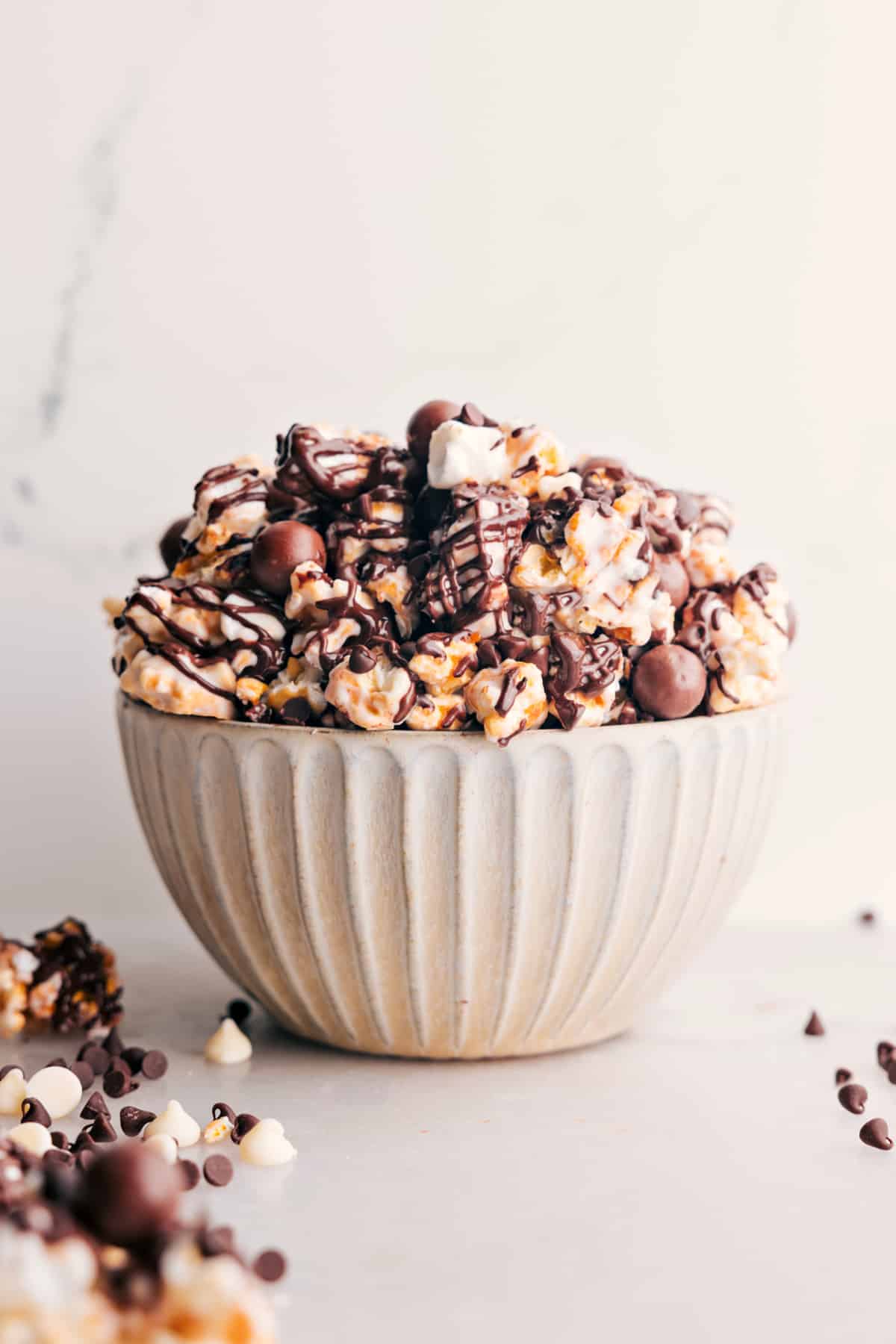 Gourmet-Style Chocolate Popcorn Chocolate Popcorn: Popcorn and chocolate malt balls mixed together in a bowl.