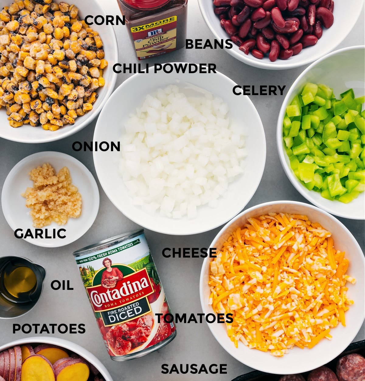 Ingredients In Crockpot Cowboy Casserole Prepped All the ingredients in this recipe are prepped for easy assembly, including the veggies, cheese, tomatoes, potatoes, oil, corn, beans, and seasonings.